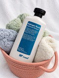 maad Hydrogen Bomb Hydrating Shampoo 400 ml bottle among rolled towels in a pink basket