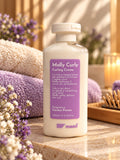 maad Molly Curly Curling Creme 200 ml bottle with purple label beside folded towels and flowers
